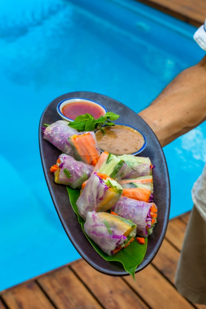 Fresh rice-paper rolls served over the pool